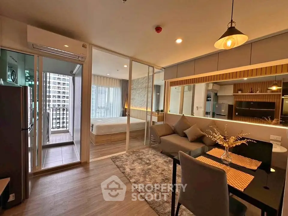 Modern open-plan living room with kitchen and bedroom in stylish apartment