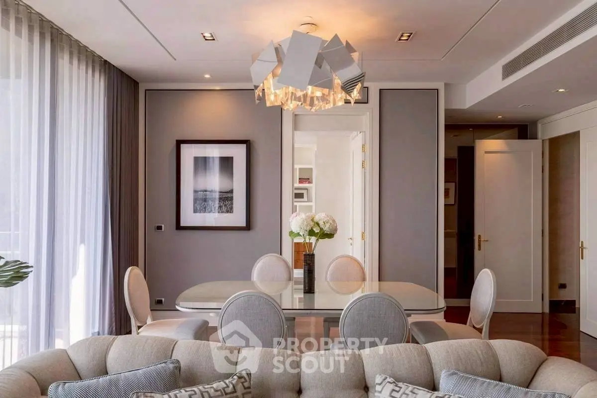 Elegant living and dining area with modern chandelier and stylish decor