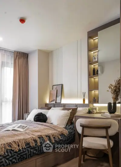 Modern bedroom with stylish decor and natural light, featuring a cozy bed and elegant furnishings.