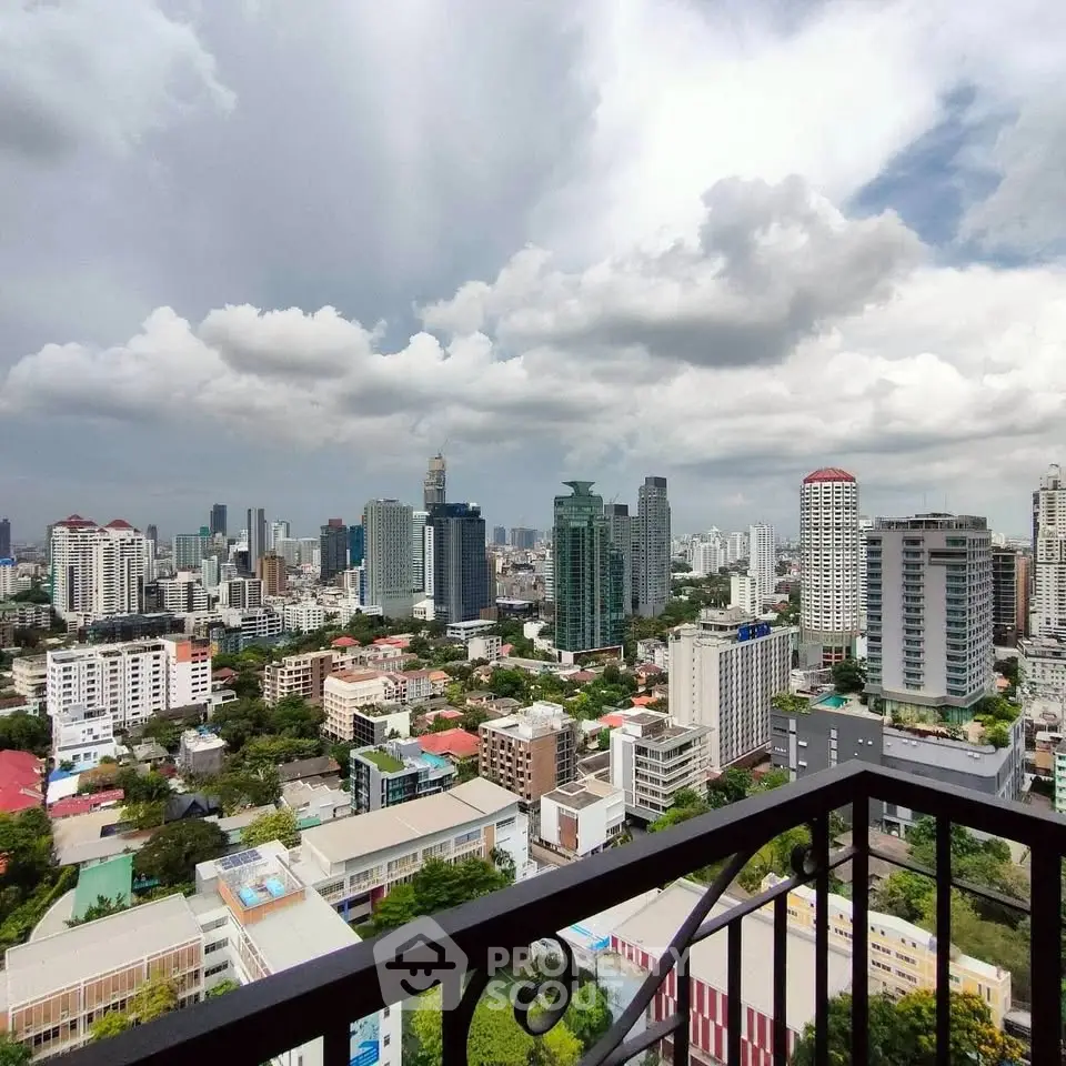 Stunning cityscape view from a high-rise balcony showcasing urban skyline and lush greenery.
