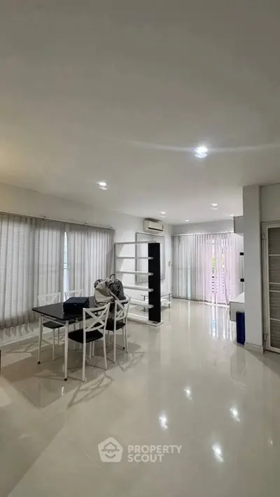 Spacious modern living room with dining area and natural light