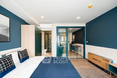 Modern bedroom with blue accents and smart TV in stylish apartment