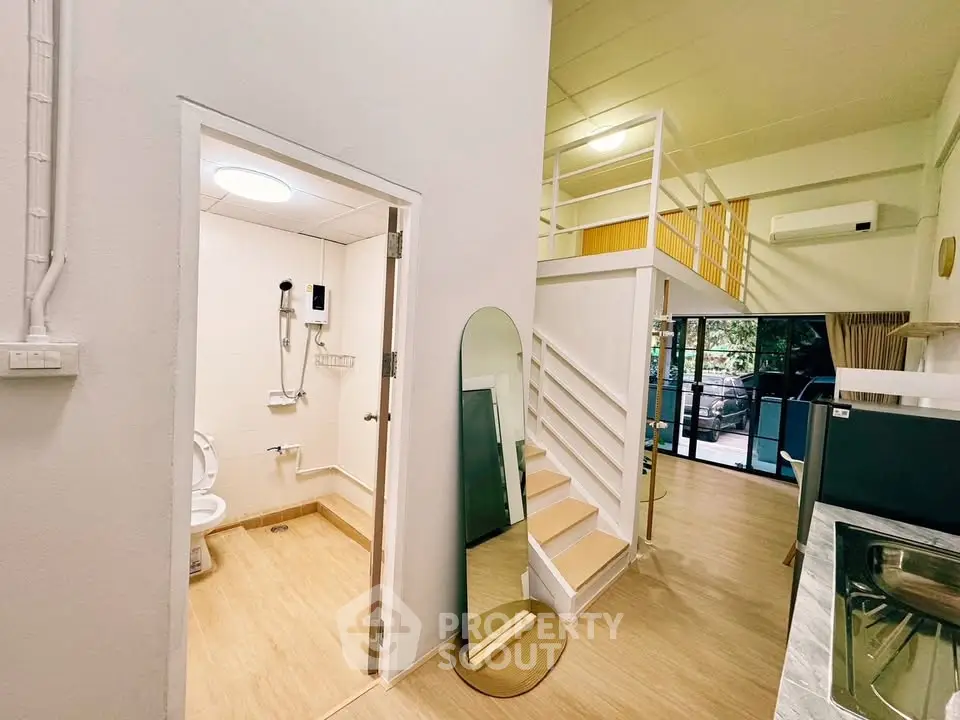Modern loft apartment with open layout, featuring a stylish bathroom and spacious living area.