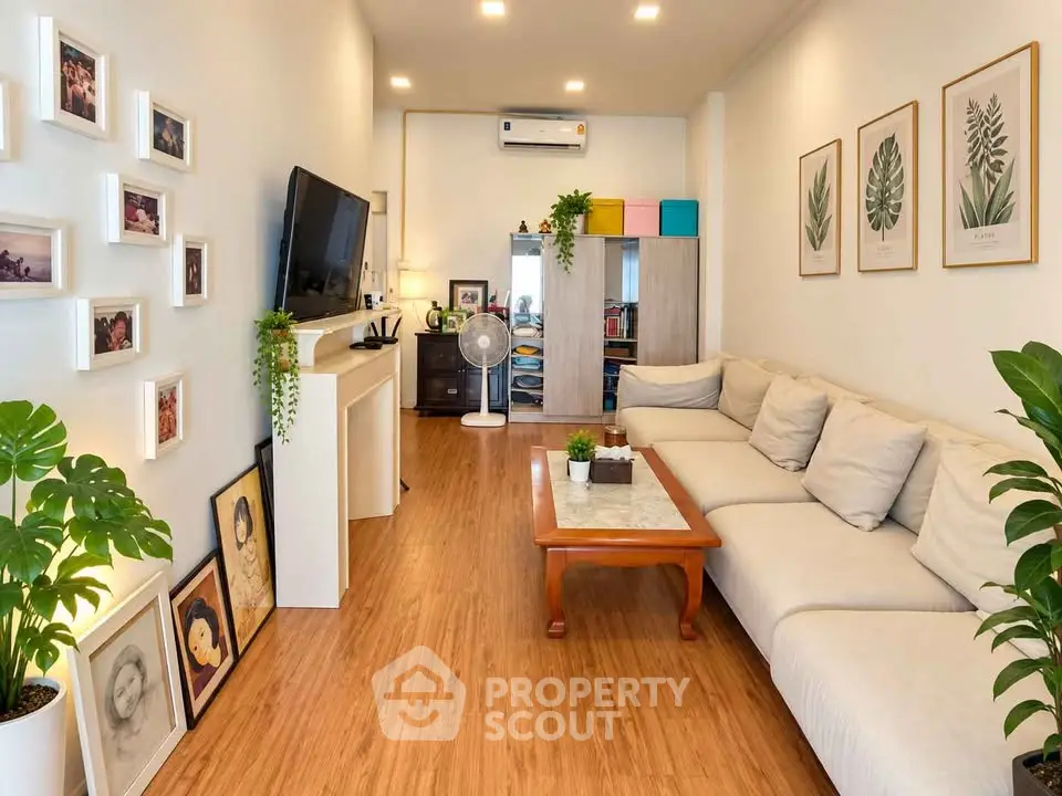 Stylish living room with modern decor, wooden flooring, and cozy seating area.