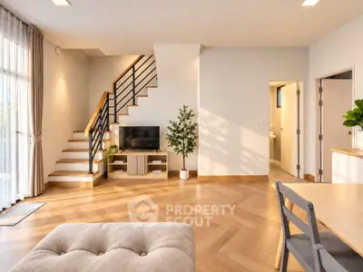 Spacious modern living room with stylish staircase and natural light