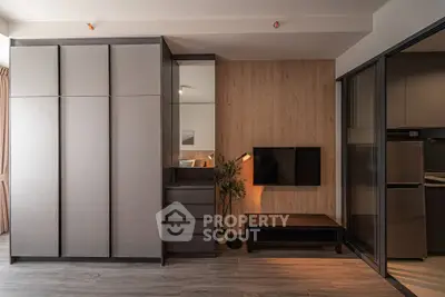 Modern living room with sleek storage and TV setup in stylish apartment