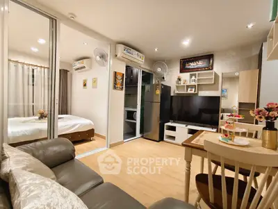 Modern open-plan living room with kitchen and bedroom in cozy apartment