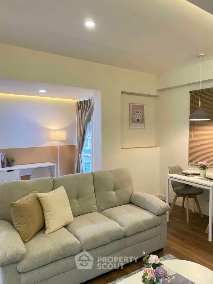 Cozy living room with plush sofa and elegant dining area in modern apartment.