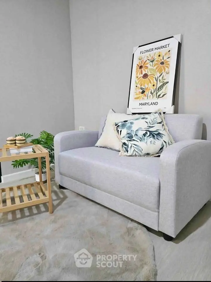 Cozy living room with stylish gray sofa and floral decor, perfect for relaxation.