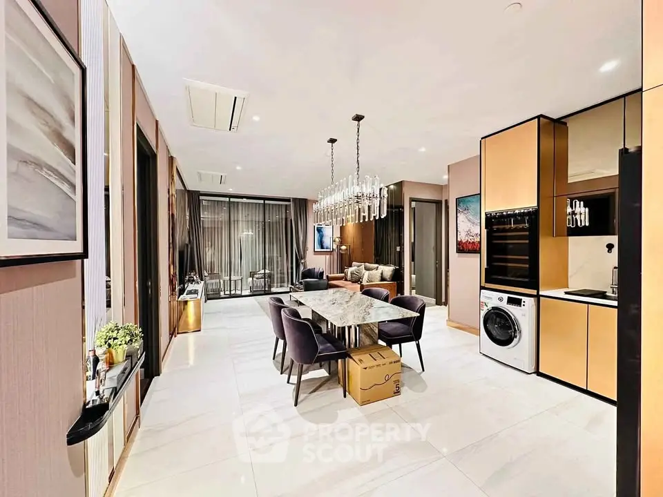 Luxurious open-plan living and dining area with modern appliances and elegant decor.