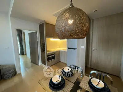 Modern kitchen with stylish lighting and dining area in contemporary apartment
