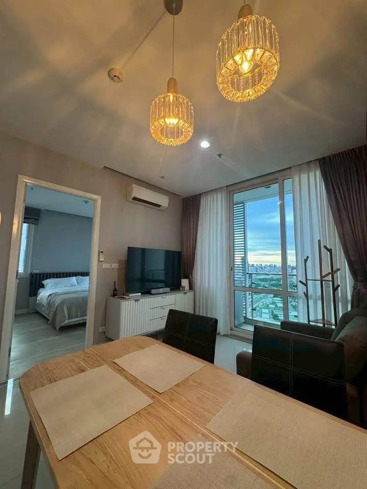 Modern living room with dining area and city view, featuring elegant lighting and stylish decor.