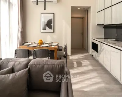 Modern open-plan living and dining area with stylish decor and natural light.