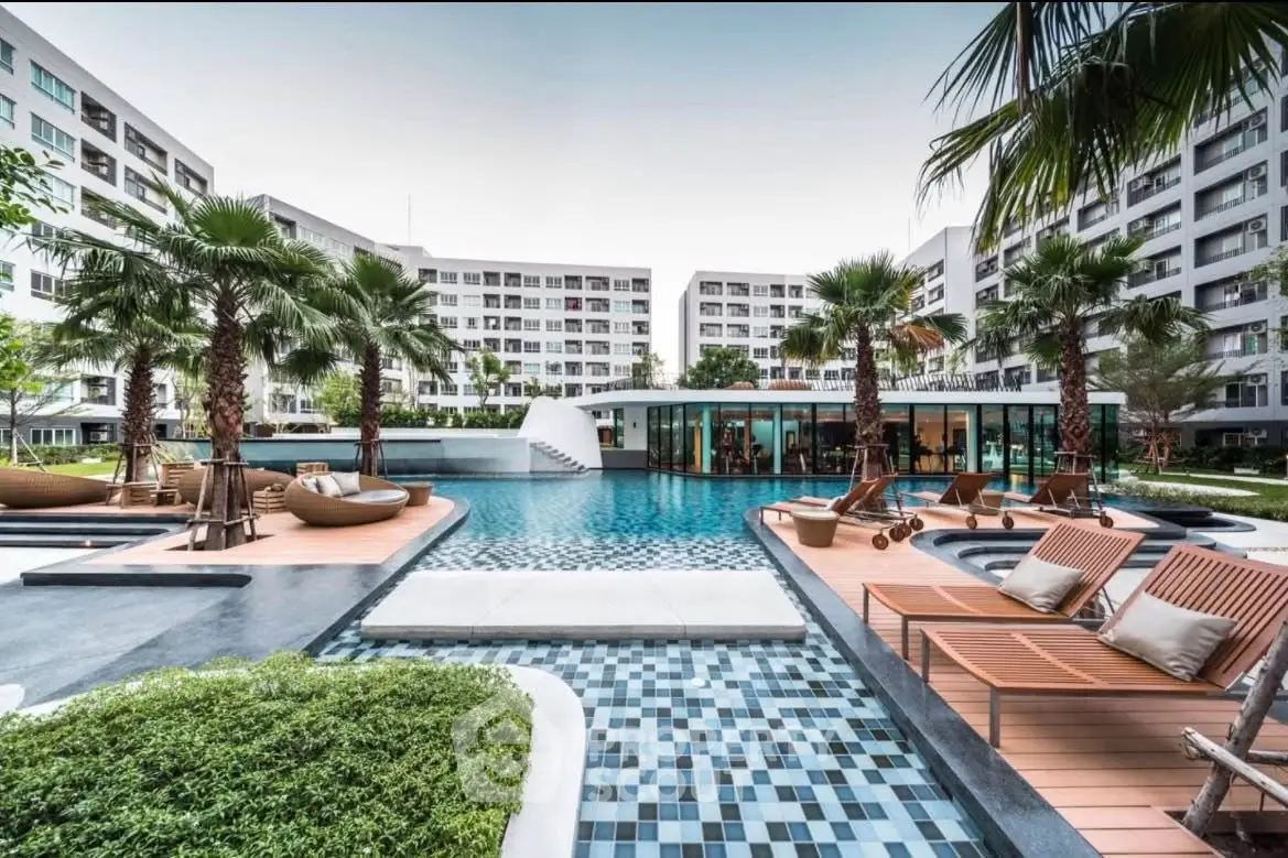 Luxurious modern apartment complex with stunning pool and lush landscaping.