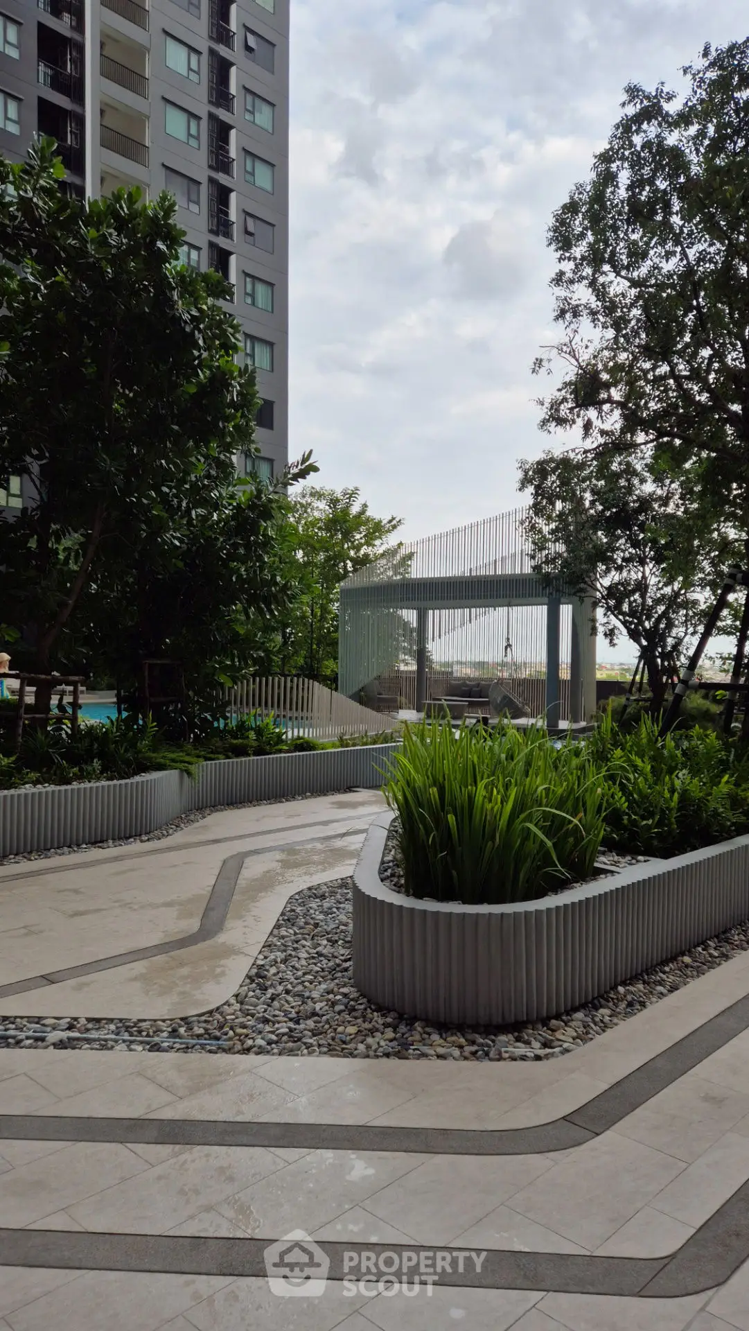 Modern apartment building with lush landscaped garden and pathway