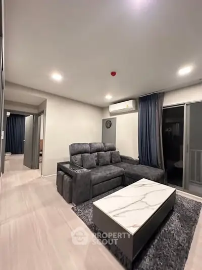 Modern living room with stylish gray sofa and marble coffee table