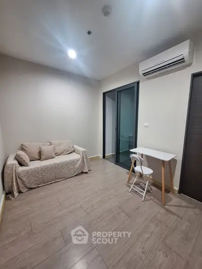 Modern minimalist living room with air conditioning and simple furniture