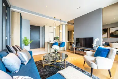 Luxurious modern living room with elegant decor and open layout, featuring plush seating and stylish furnishings.