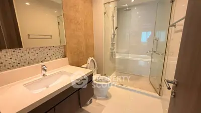 Modern bathroom with glass shower and elegant fixtures in a contemporary apartment.