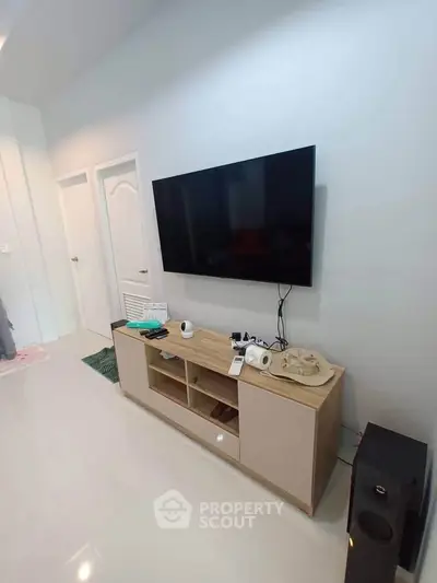 Modern living room with sleek TV setup and stylish console table