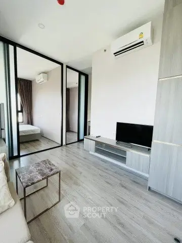 Modern living room with sleek design, featuring air conditioning and stylish furniture in a contemporary apartment.