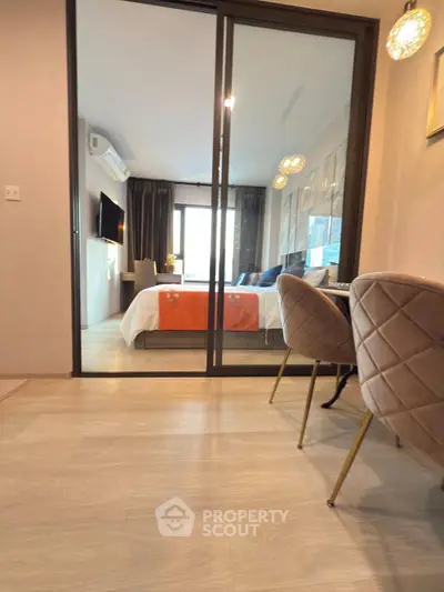 Modern apartment interior with stylish bedroom and dining area, featuring elegant decor and natural light.