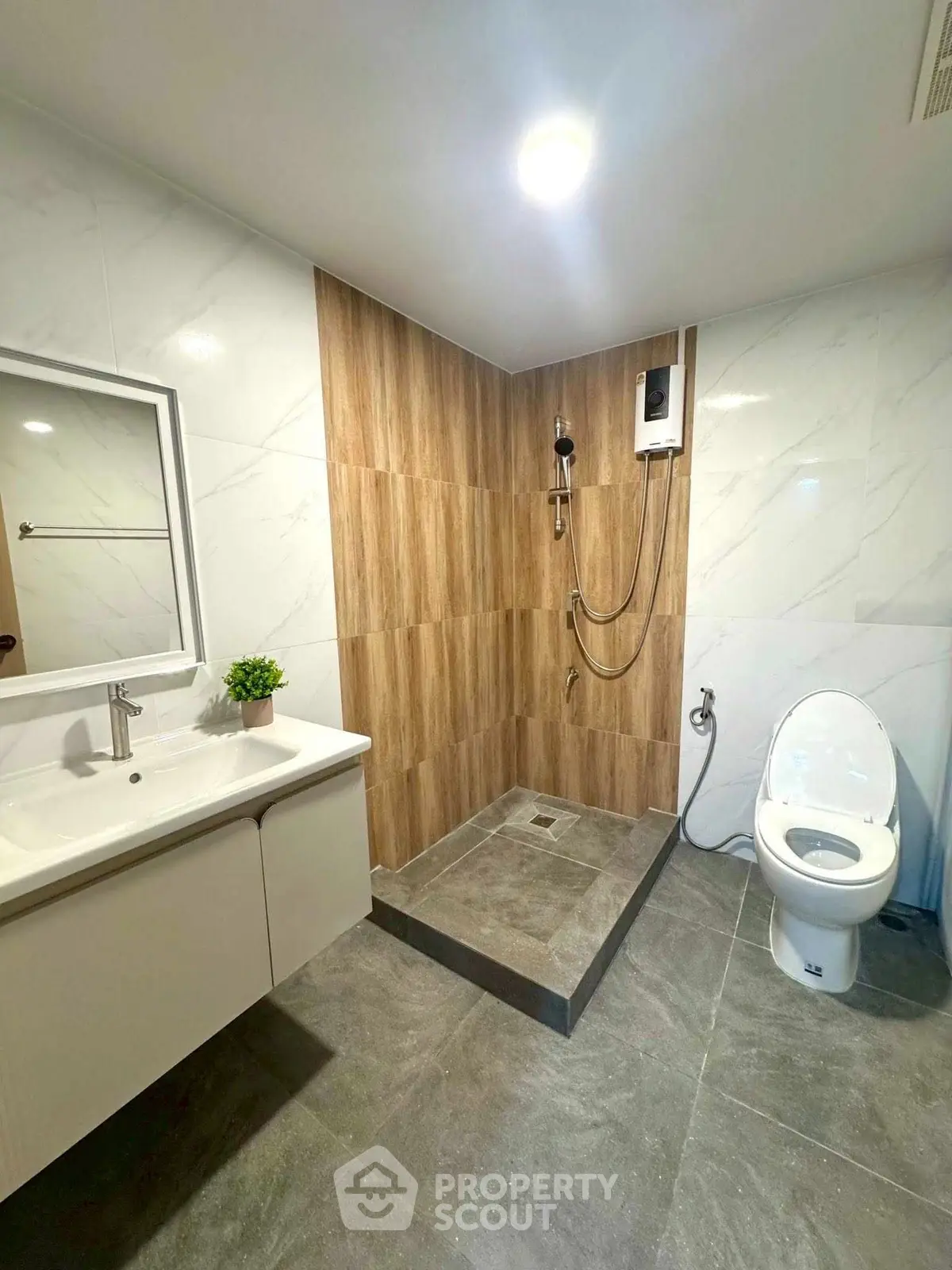 Modern bathroom with sleek shower and elegant fixtures in a contemporary apartment.