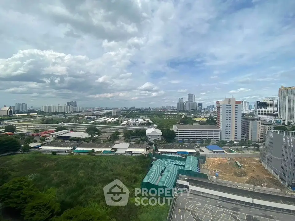 Stunning cityscape view from high-rise building showcasing urban skyline and lush greenery.