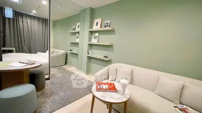 Modern living room with cozy sofa, elegant decor, and soft lighting in a stylish apartment.
