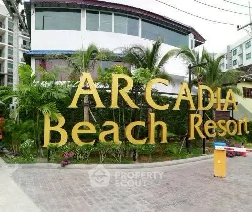 Arcadia Beach Resort entrance with lush greenery and modern architecture.