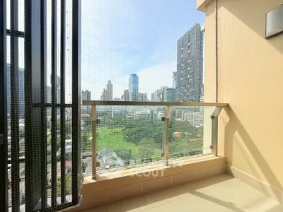 Spacious balcony with stunning cityscape view in modern high-rise apartment.