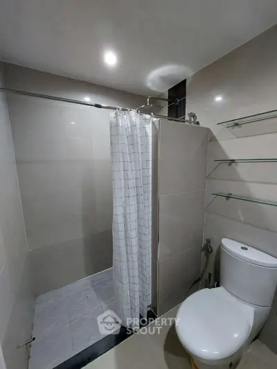 Modern bathroom with shower curtain and sleek design