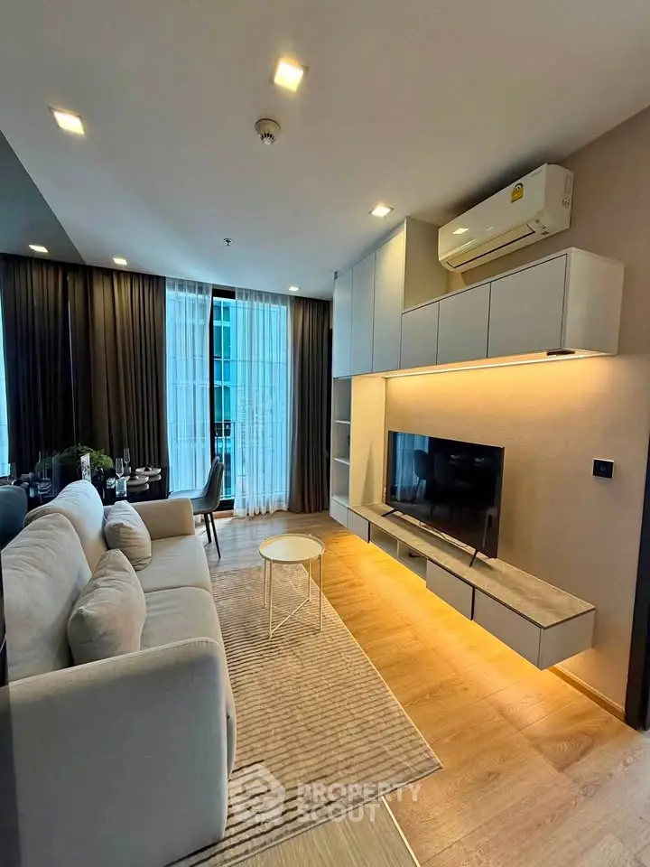 Modern living room with sleek furniture and ambient lighting in a stylish apartment.