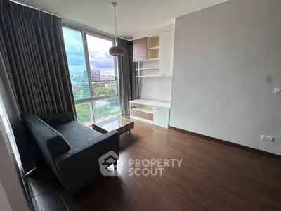 Modern living room with large window and stylish furniture in urban apartment