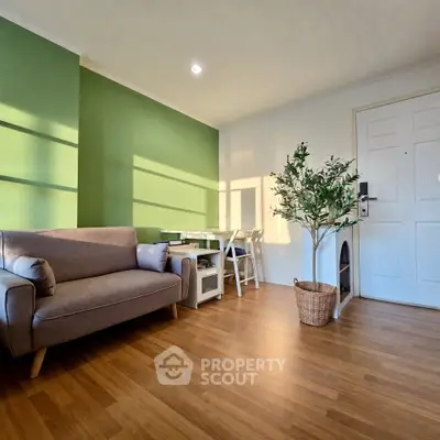 Charming living room with green accent wall and cozy seating area