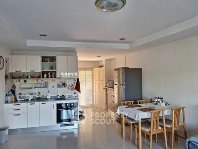 Spacious kitchen with dining area featuring modern appliances and ample natural light.