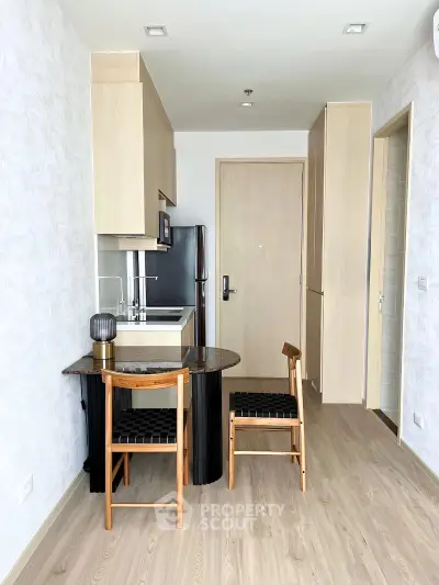 Modern compact kitchen with dining area in stylish apartment