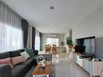 Spacious modern living room with stylish decor and large windows