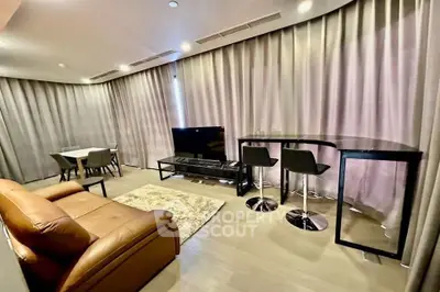 Modern living room with stylish furniture and elegant decor, featuring a cozy seating area and dining space.