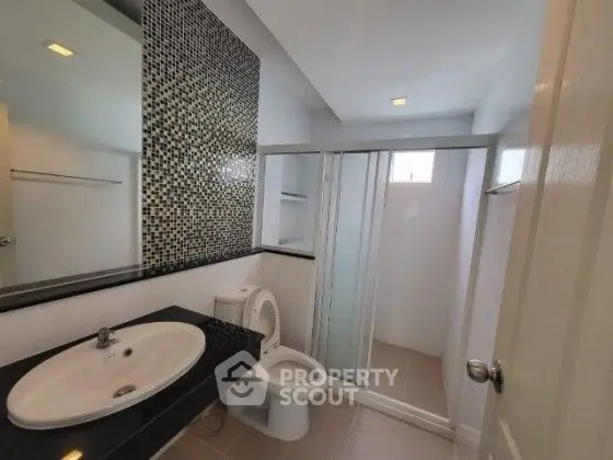 Modern bathroom with sleek design and mosaic tile accent wall