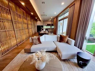 Luxurious modern living room with elegant wooden accents and large windows offering serene garden views.