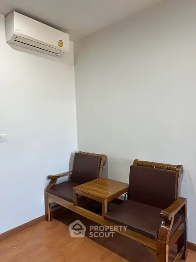 Cozy corner with wooden seating and air conditioning in modern apartment.
