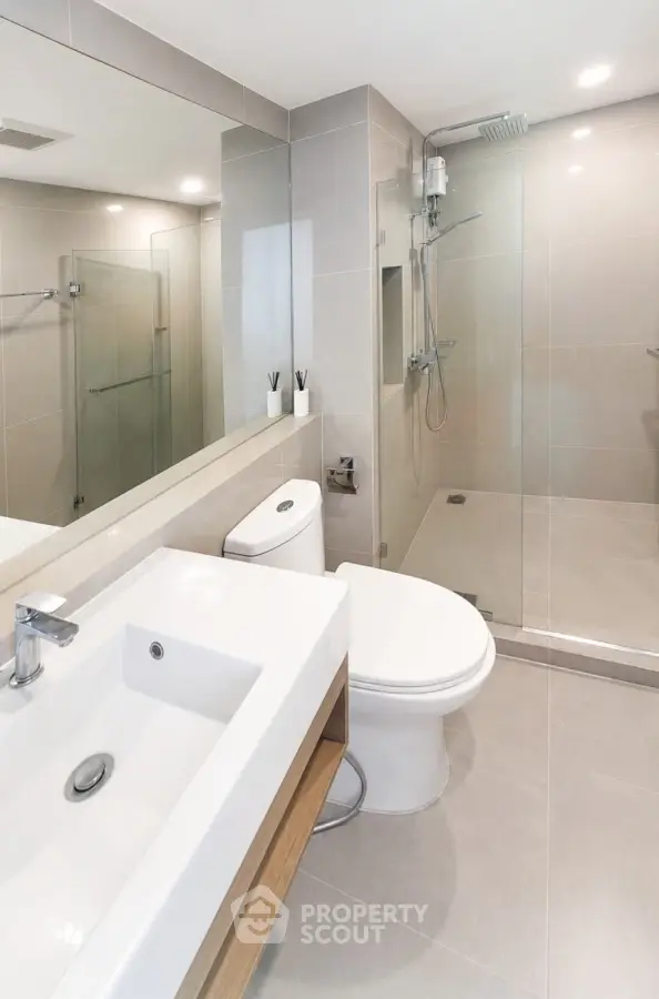 Modern bathroom with sleek fixtures and glass shower enclosure