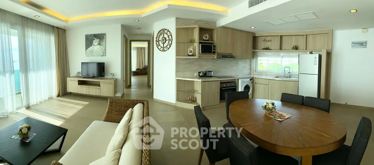 Spacious open-plan living room and kitchen with modern appliances and elegant decor.