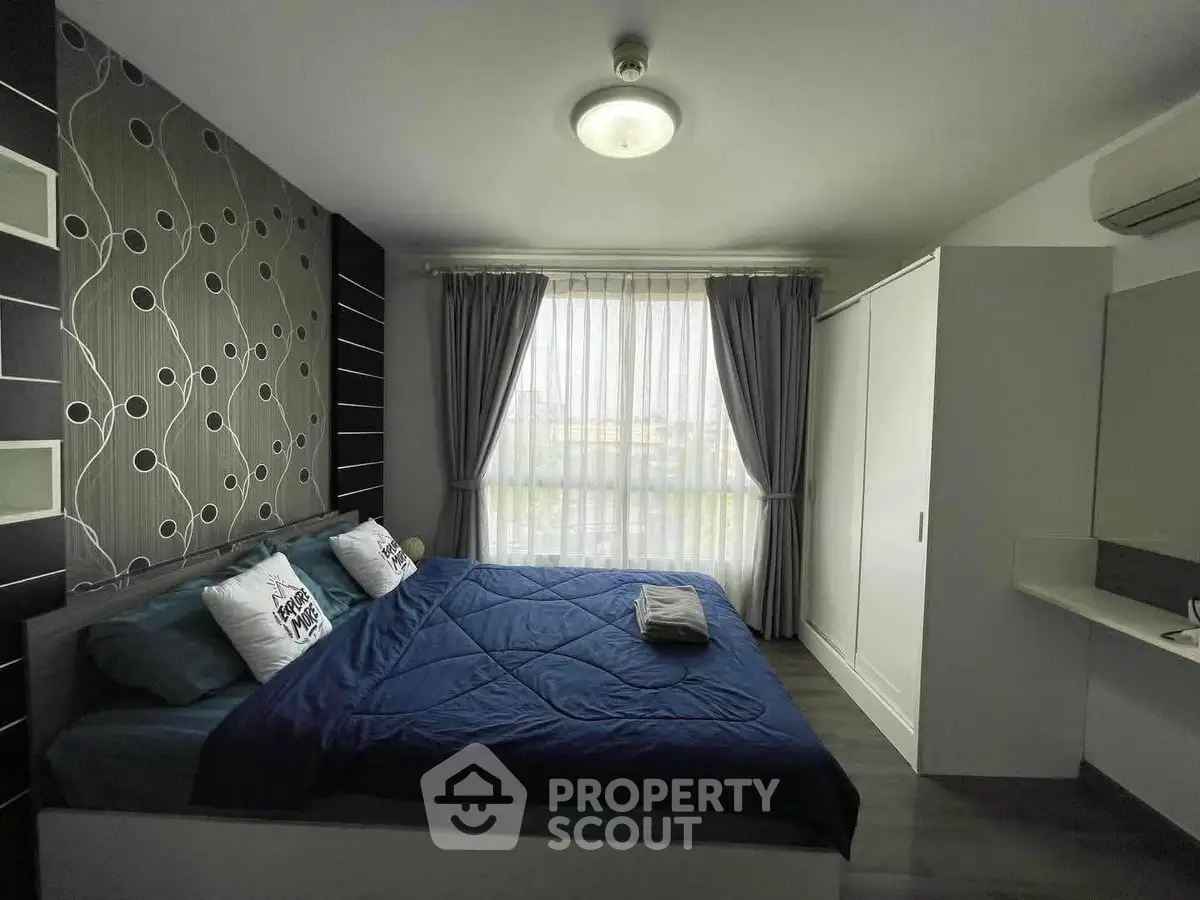 Modern bedroom with stylish decor and large window for natural light