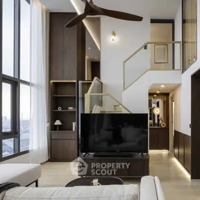 Luxurious modern living room with high ceilings and large windows offering stunning city views.