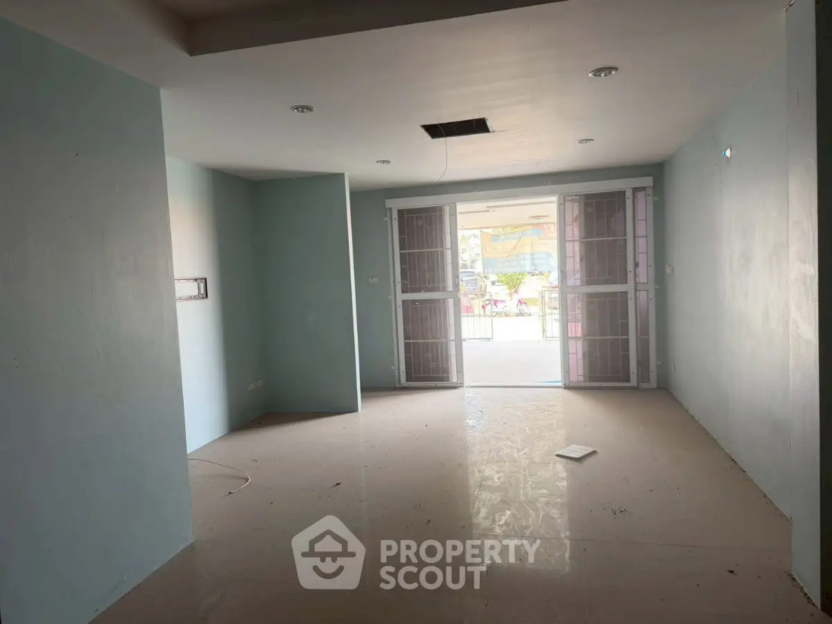 Spacious unfurnished living room with large windows and natural light