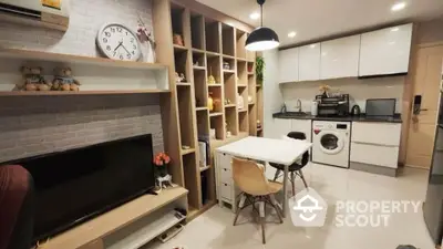 Modern open-plan living room with integrated kitchen and stylish shelving