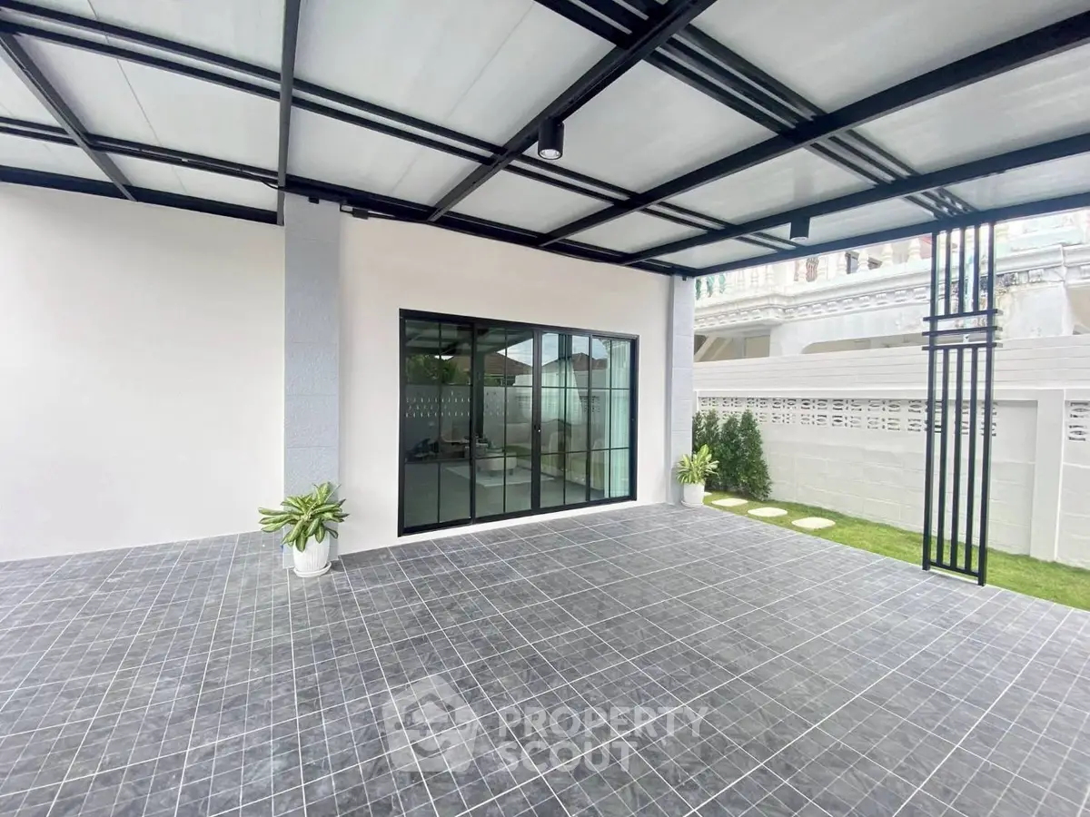 Modern covered patio with sleek tiles and garden view
