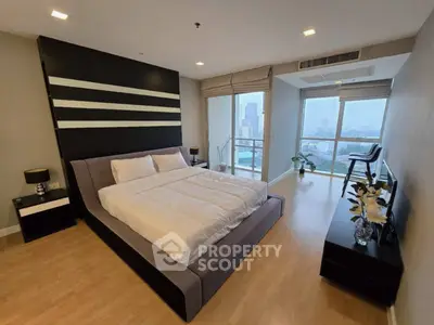 Spacious modern bedroom with city view and elegant decor
